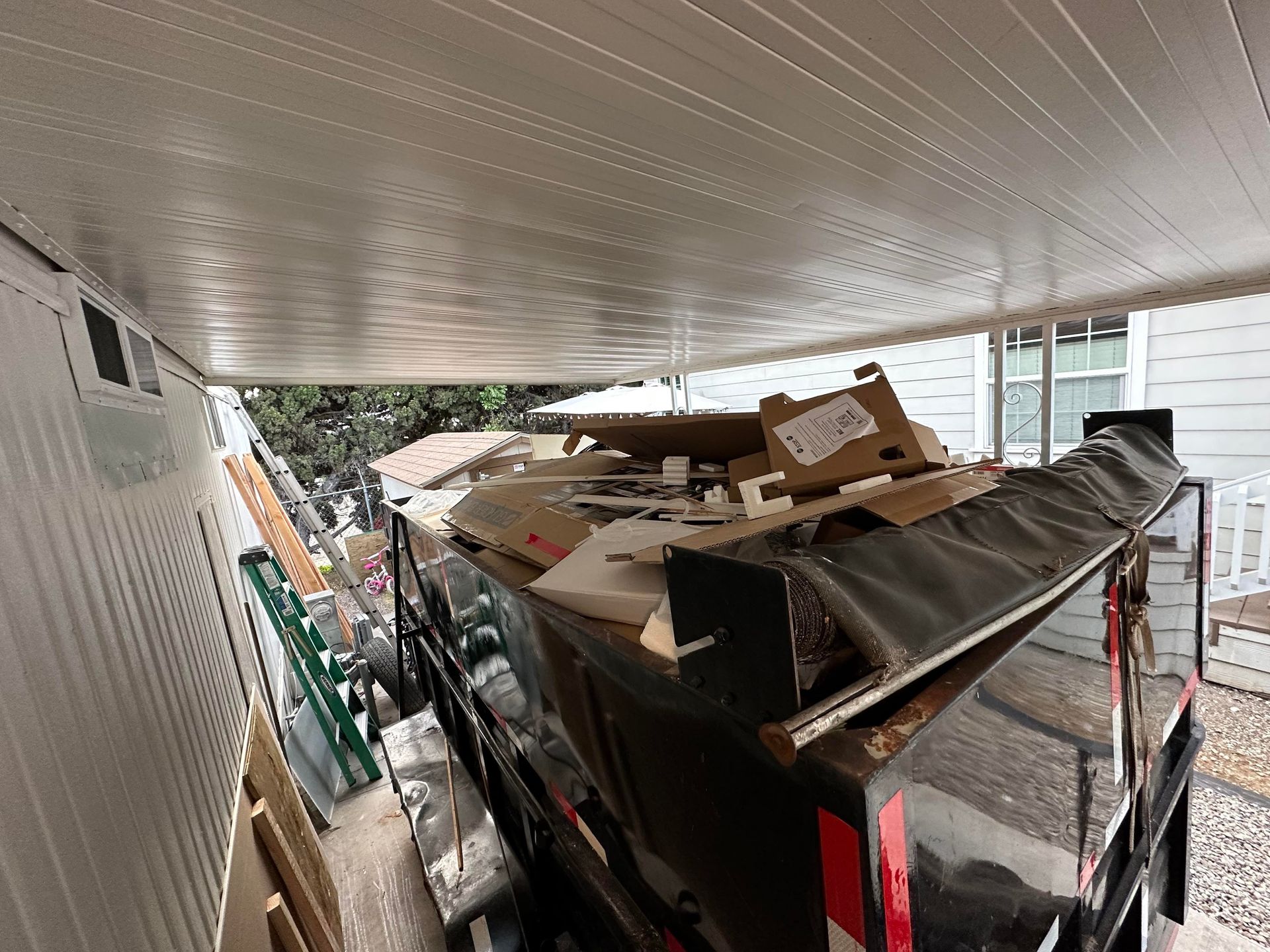 Junk removal trailer loaded with debris El Cajon